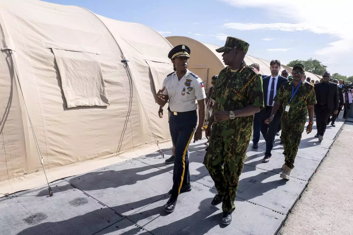 FILE - Godfrey Otunga, Kenyan head of a UN-backed multinational police force, right, speaks to the new Haitian Chief of Police Rameau Normil during a tour for U.S. Ambassador to the United Nations Linda Thomas-Greenfield at their base in Port-au-Prince, Haiti, July 22, 2024. (Roberto Schmidt/Pool Photo via AP, File)