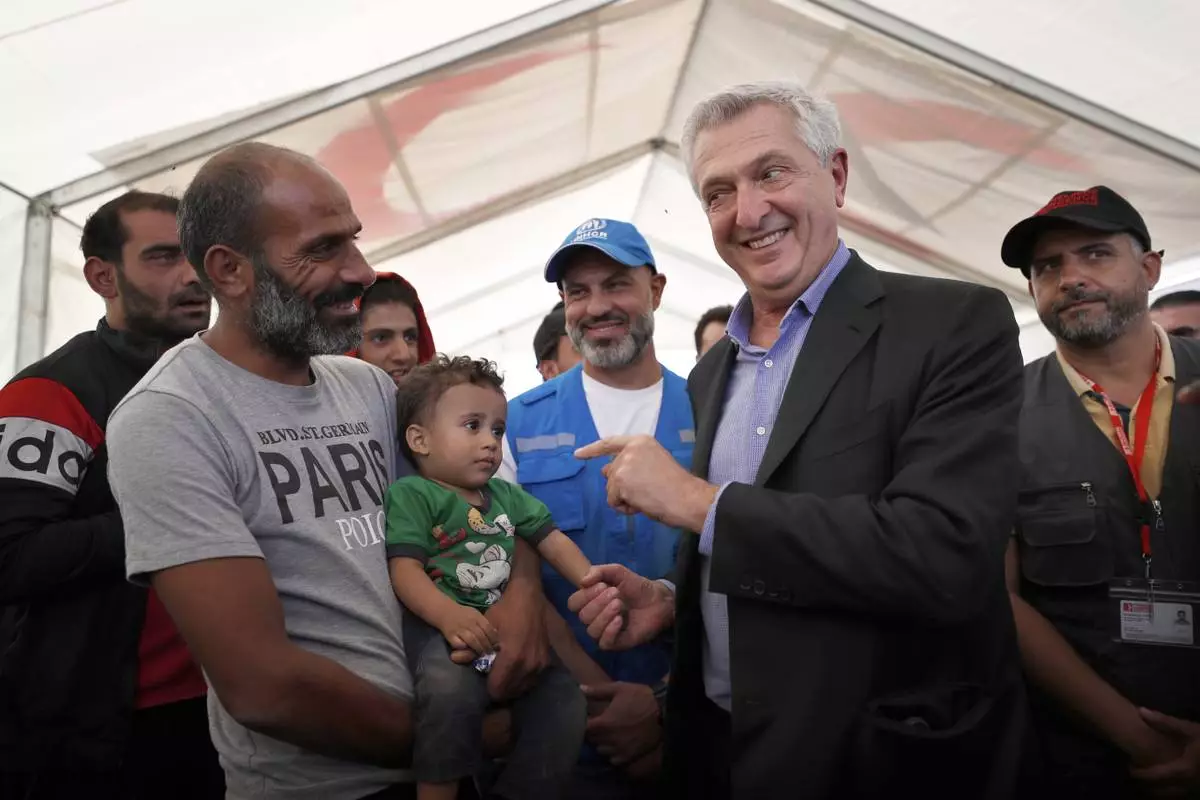 UN High Commissioner for Refugees (UNHCR), Filippo Grandi, right, gestures as he talks to a man who fled the war in Lebanon at the Syrian border crossing point, in Jdeidet Yabous, Syria, Oct. 7, 2024. (AP Photo/Omar Sanadiki, File)