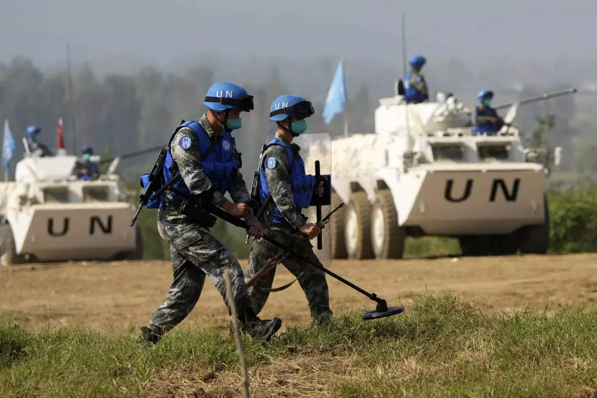 FILE - Chinese United Nations troop practice sweeping for mines during the Shared Destiny 2021 drill at the Queshan Peacekeeping Operation training base in Queshan County in central China's Henan province Sept. 15, 2021. (AP Photo/Ng Han Guan, File)