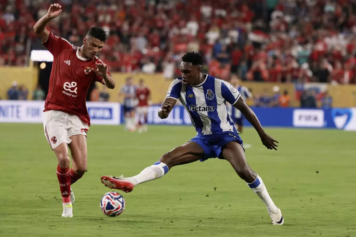 Porto's Samu Aghehowa and Al Ahly's Achraf Dari go after the ball during the Club World Cup Group A soccer match between FC Porto and Al Ahly in East Rutherford, N.J., Monday, June 23, 2025. (AP Photo/Adam Hunger)