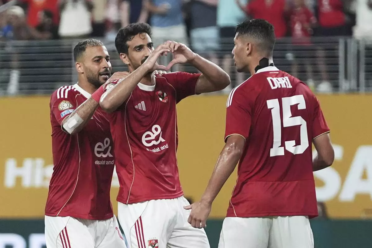 Al Ahly's Mohamed Ali Ben Romdhane, centre, gestures to supporters after scoring his team's fourth goal during the Club World Cup Group A soccer match between FC Porto and Al Ahly in East Rutherford, N.J., Monday, June 23, 2025. (AP Photo/Frank Franklin II)