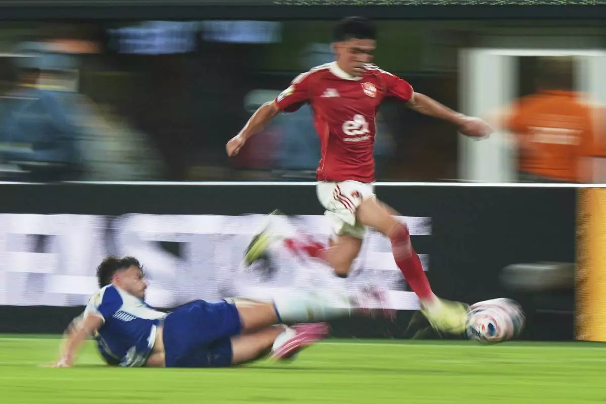 Al Ahly's Achraf Dari is tackled by Porto's Pepe, left, during the Club World Cup Group A soccer match between FC Porto and Al Ahly in East Rutherford, N.J., Monday, June 23, 2025. (AP Photo/Frank Franklin II)