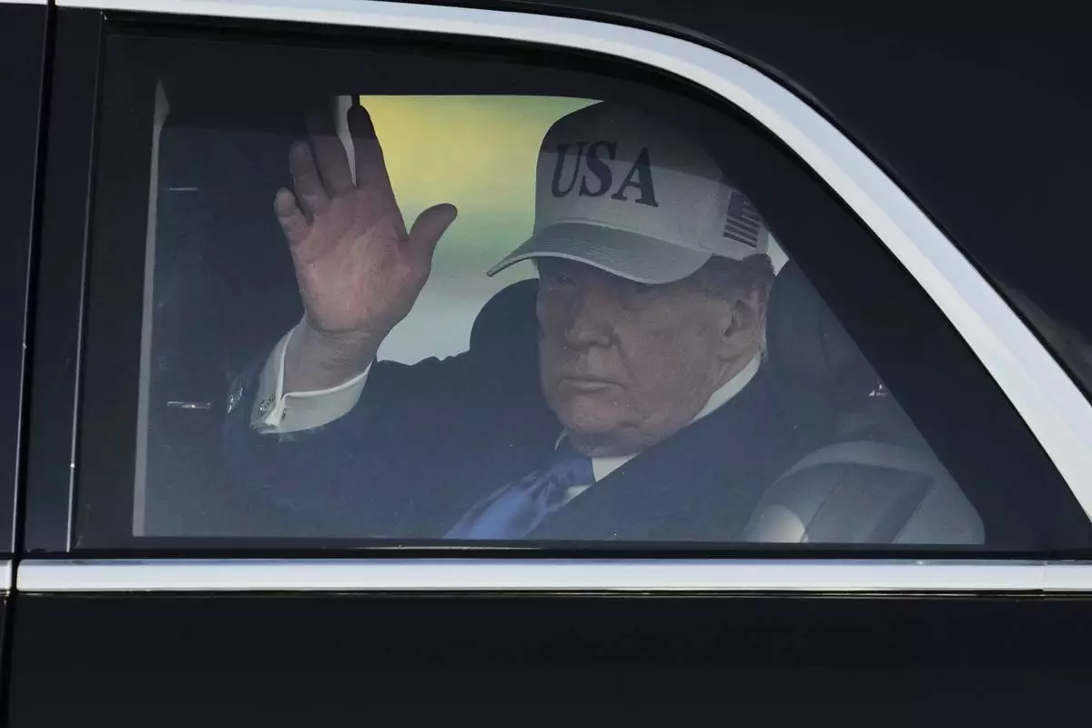 President Donald Trump waves after arriving at Amsterdam Schiphol Airport ahead of the NATO summit, taking place in The Hague, Netherlands, Tuesday, June 24, 2025. (AP Photo/Peter Dejong)