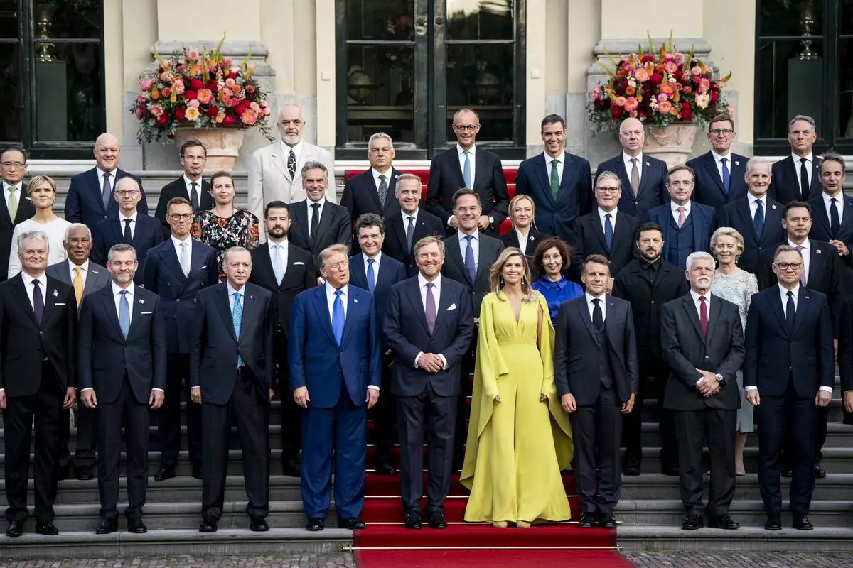 US President Donald Trump, center left, along with the King Willem-Alexander and Queen Maxima of the Netherlands, center, poses for a family photo at the 2025 NATO summit in The Hague, on Tuesday, June 24, 2025. (Haiyun Jiang/Pool Photo via AP)