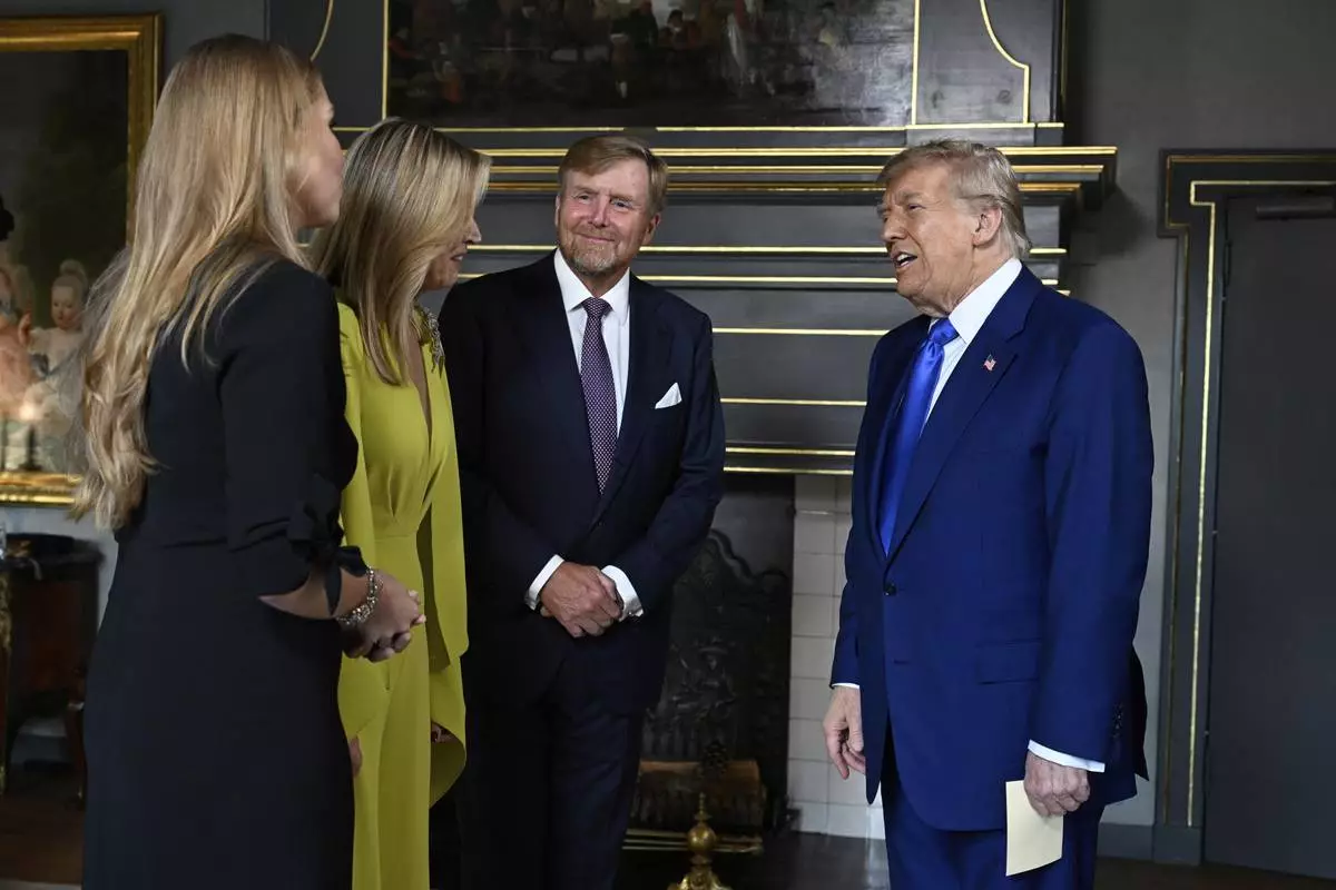 President Donald Trump, right, is welcomed by Netherland's King Willem Alexander, Netherland's Queen Maxima and Netherland's Crown Princess Amalia as he arrives for a formal dinner at the Paleis Huis ten Bosch ahead of the NATO summit in The Hague, Netherlands, Tuesday, June 24, 2025. (Misha Schoemakers, Pool Photo via AP)