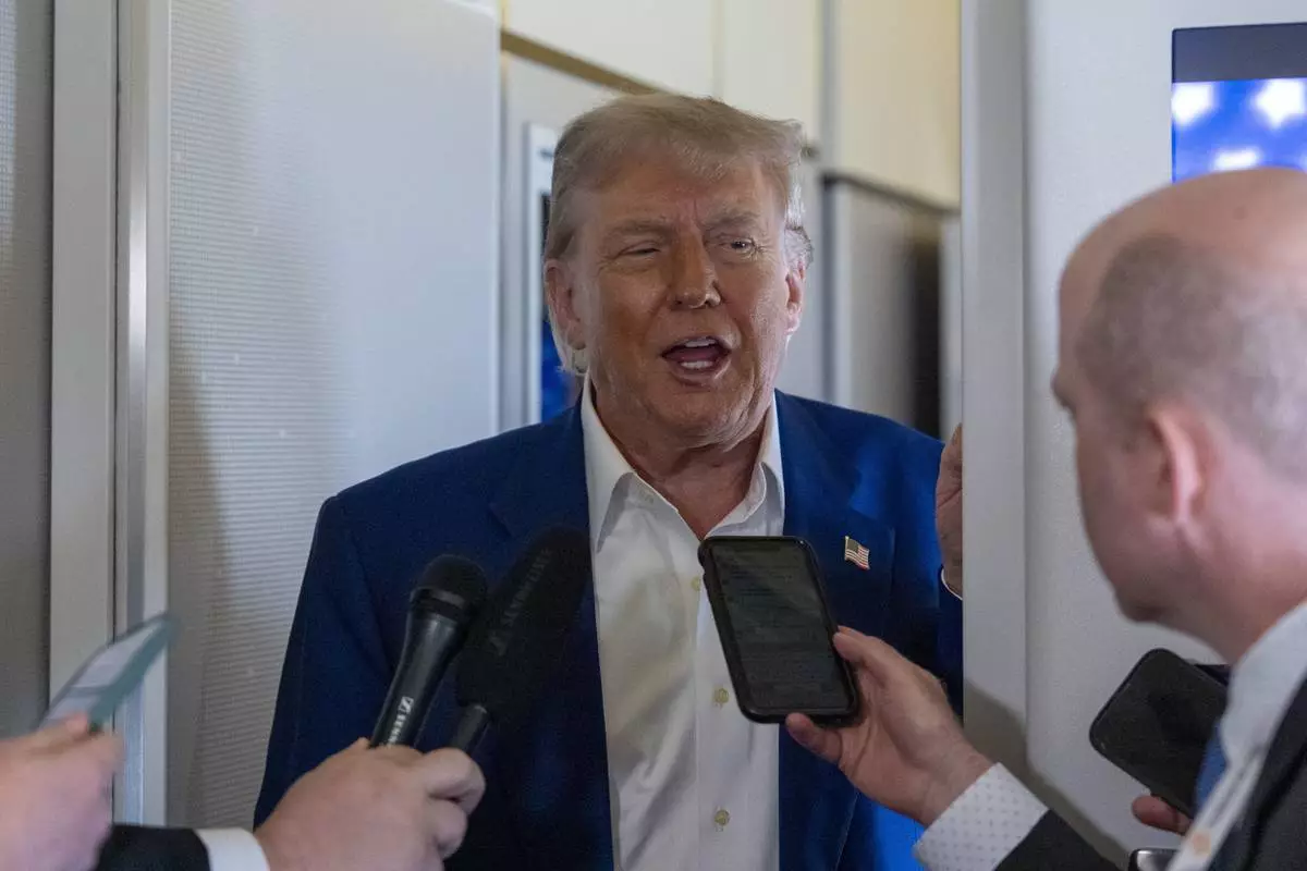President Donald Trump speaks with reporters on Air Force One while in flight from Joint Base Andrews, Md., to Amsterdam, Netherlands, Tuesday, June 24, 2025. (AP Photo/Alex Brandon)