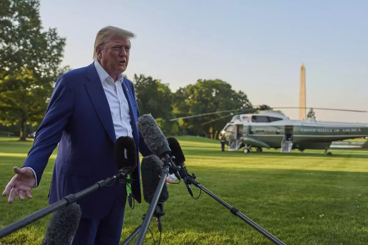 President Donald Trump speaks with reporters before boarding Marine One on the South Lawn of the White House, Tuesday, June 24, 2025, in Washington. (AP Photo/Evan Vucci)