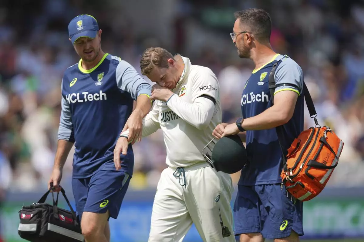 Australia's Steve Smith reacts in pain as he leaves the field after getting hurt while fielding on day three of the World Test Championship final between South Africa and Australia at Lord's cricket ground in London, Friday, June 13, 2025. (AP Photo/Kirsty Wigglesworth)