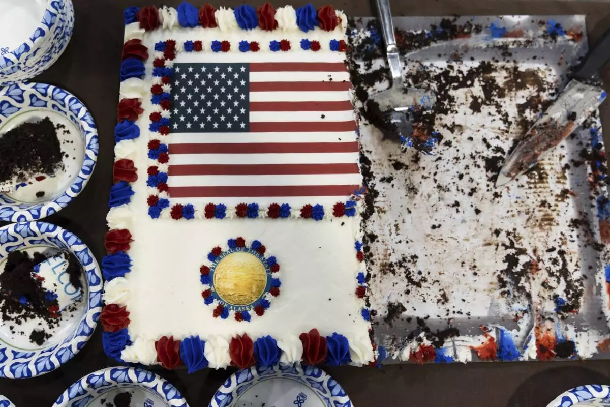 A U.S. flag is seen on a piece of cake for attendees after a news conference near the Trans-Alaska Pipeline at the Pump Station 1 on Monday, June 2, 2025, located near Deadhorse, Alaska, on the state's prodigious North Slope. (AP Photo/Jenny Kane)