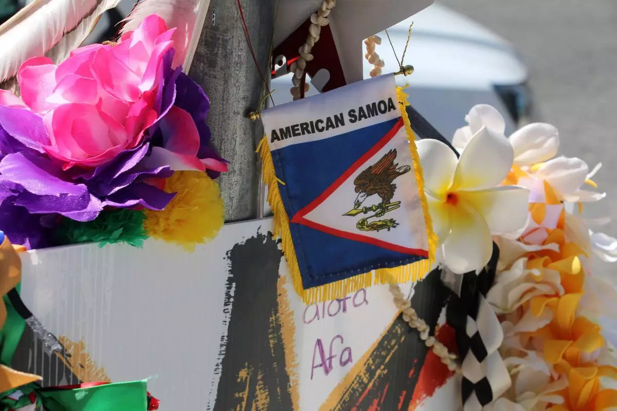 A makeshift memorial for Arthur Folasa Ah Loo, known to friends and family as Afa, is seen Tuesday, June 17, 2025, in downtown Salt Lake City, Utah, on the block where Ah Loo was fatally shot during a "No Kings" protest on Saturday, June 14. (AP Photo/Hannah Schoenbaum)