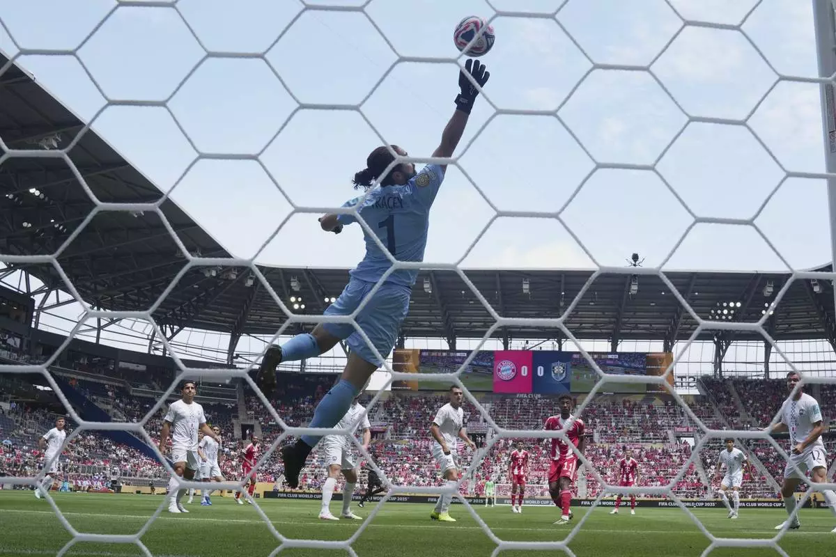 Bayern Munich's Kingsley Coman, center right, heads the ball past Auckland City's Conor Tracey to score the first goal during the Club World Cup group C soccer match between Bayern Munich and Auckland City in Cincinnati, Sunday, June 15, 2025. (AP Photo/Jeff Dean)