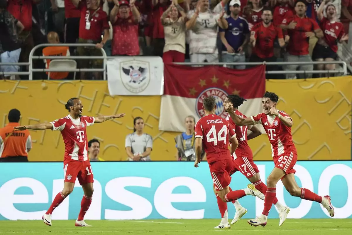 Bayern Munich players celebrate their second goal by teammate Michael Olise, second right, during the Club World Cup Group C soccer match between Bayern Munich and Boca Juniors in Miami Gardens, Fla., Friday, June 20, 2025. (AP Photo/Lynne Sladky)