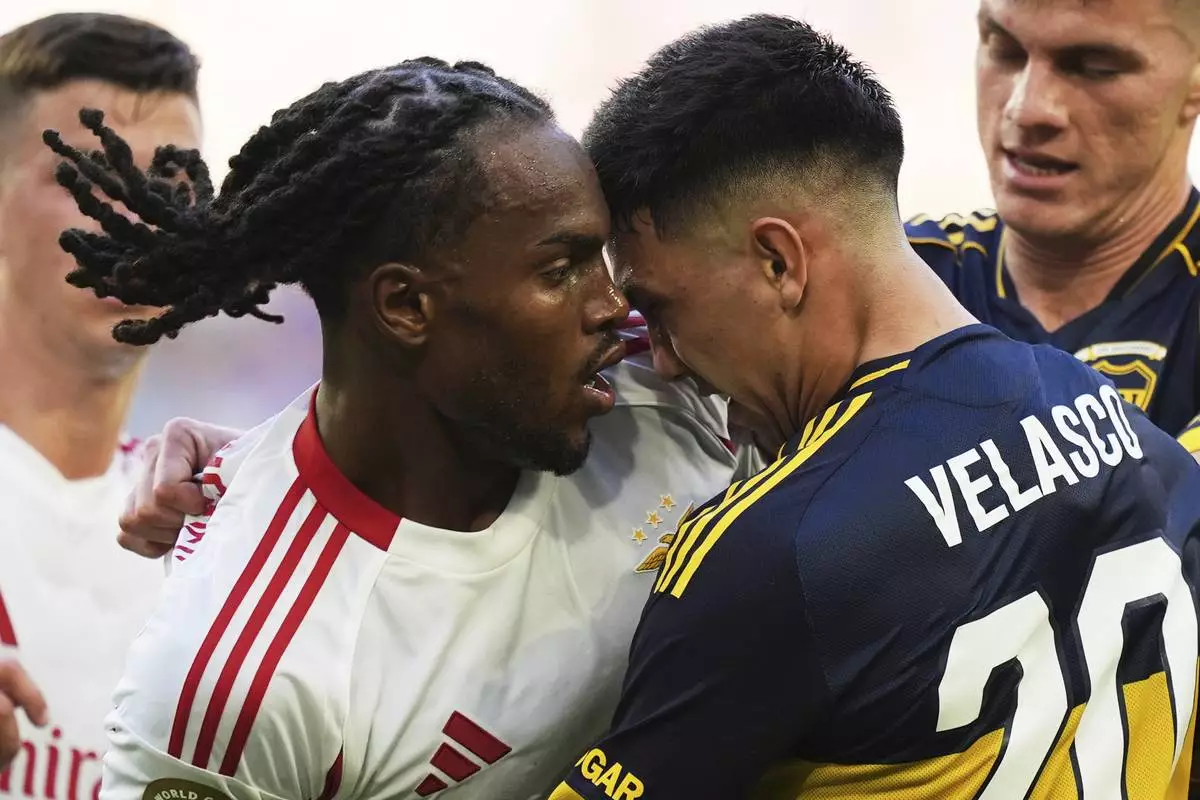 Benfica's Renato Sanches, left, and Boca Juniors' Alan Velasco confront each other during the Club World Cup group C soccer match between Boca Juniors and Benfica in Miami Gardens, Fla., Monday, June 16, 2025. (AP Photo/Rebecca Blackwell)