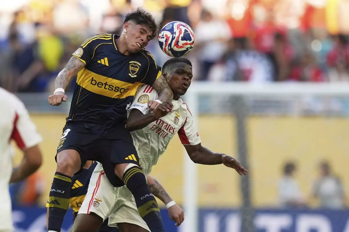 Benfica's Florentino Luis, right, and Boca Juniors' Carlos Palacios go for a header during the Club World Cup group C soccer match between Boca Juniors and Benfica in Miami Gardens, Fla., Monday, June 16, 2025. (AP Photo/Rebecca Blackwell)