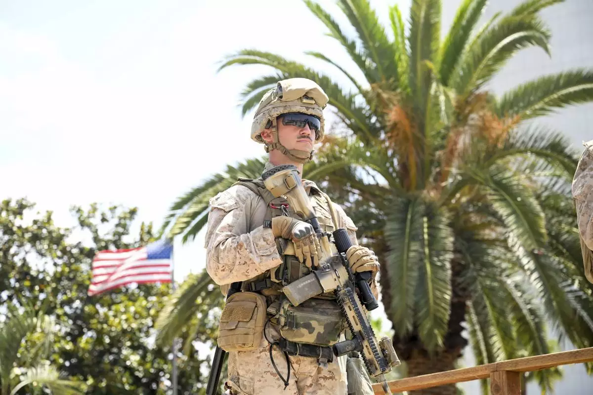 A U.S Marine guards a federal building, Friday, June 13, 2025, in Los Angeles (AP Photo/Noah Berger)
