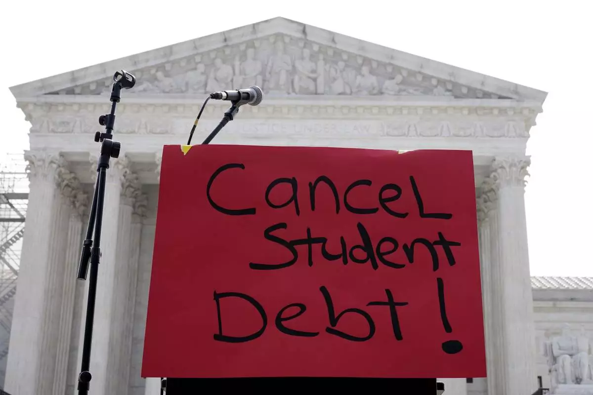 FILE - A sign reading "cancel student debt" is seen outside the Supreme Court, June 30, 2023, in Washington. (AP Photo/Mariam Zuhaib, File)