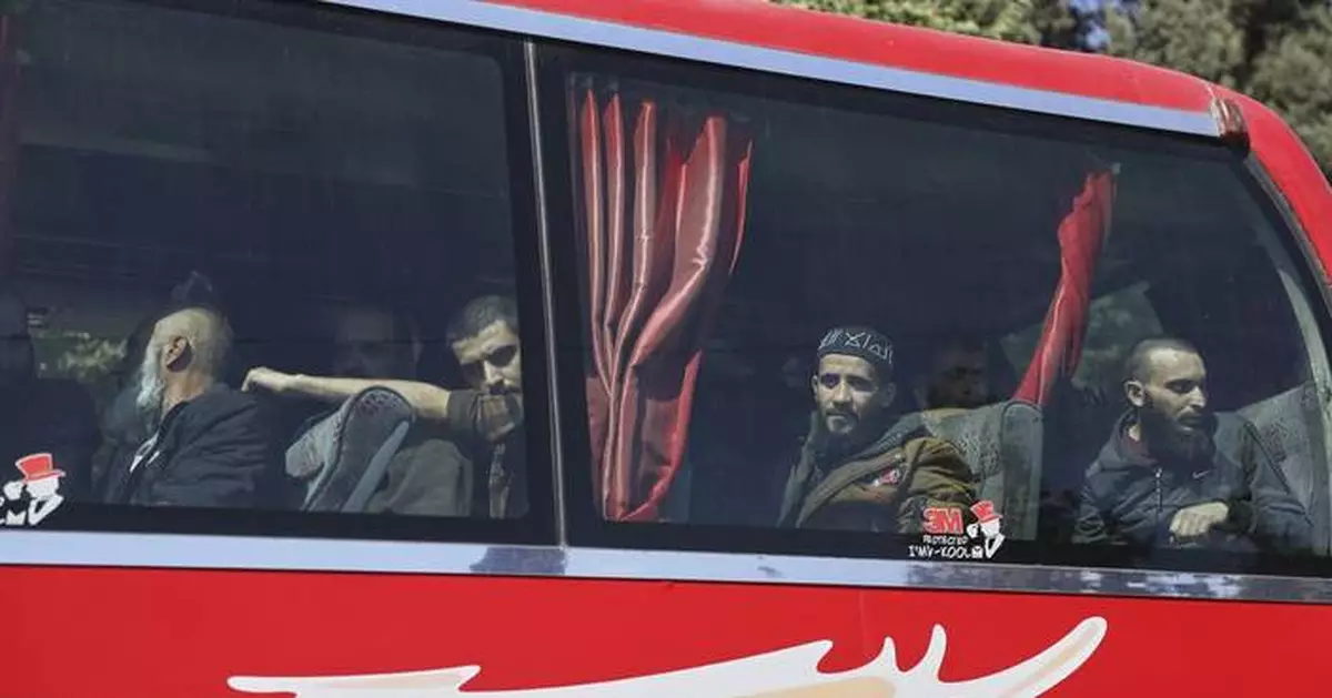 Syrian government and Kurdish-led force exchange prisoners in a step toward easing tensions