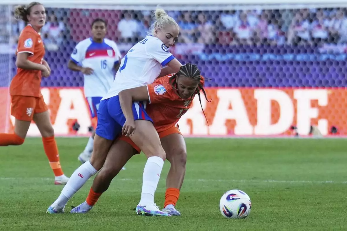 England's Alex Greenwood fights for the ball with Netherlands' Chasity Grant, right, during the Euro 2025, group D, soccer match between England and the Netherlands at Stadion Letzigrund in Zurich, Switzerland, Wednesday, July 9, 2025. (AP Photo/Alessandra Tarantino)