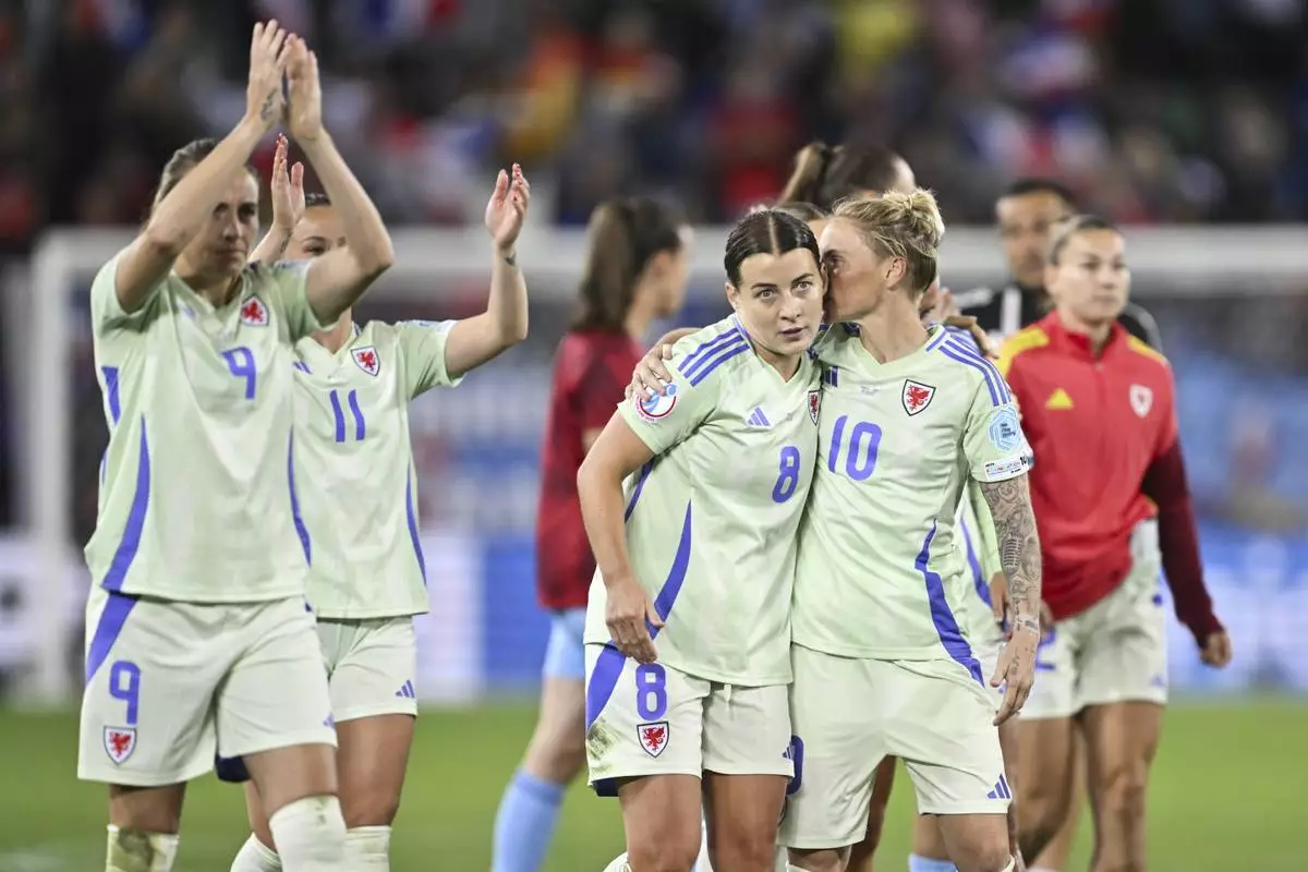 Wales' Angharad Jane James, left, and Jessica Anne Fishlock react after the UEFA Women's EURO 2025 Group D soccer match against France at the Arena St. Gallen in St. Gallen, Switzerland, Wednesday, July 9, 2025. (Gian Ehrenzeller/Keystone via AP)