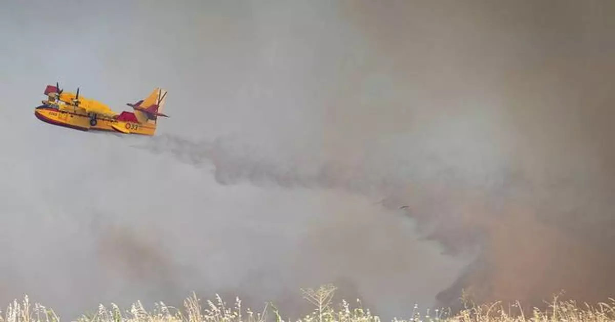 An uncontrolled wildfire sends a cloud of smoke over Spain's capital