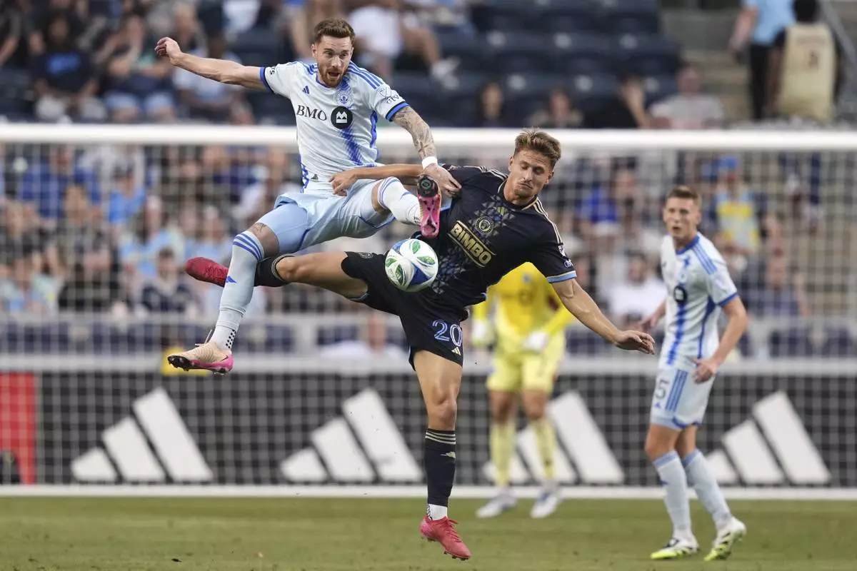 CORRECTS PLAYER'S NAME TO JOEL WATERMAN NOT TYRESE SPICER AND TEAM TO CF MONTREAL NOT TORONTO FC - CF Montreal's Joel Waterman, left, and Philadelphia Union's Bruno Damiani collide during the first half of an MLS soccer match, Wednesday, July 16, 2025, in Chester, Pa. (AP Photo/Matt Slocum)