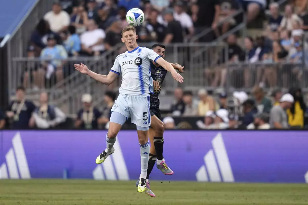 CORRECTS TEAM NAME TO CF MONTREAL NOT TORONTO FC AND CORRECTS MONTREAL PLAYER'S NAME - CF Montreal's Brandan Craig, left, and Philadelphia Union's Tai Baribo leap for the ball during the first half of an MLS soccer match, Wednesday, July 16, 2025, in Chester, Pa. (AP Photo/Matt Slocum)