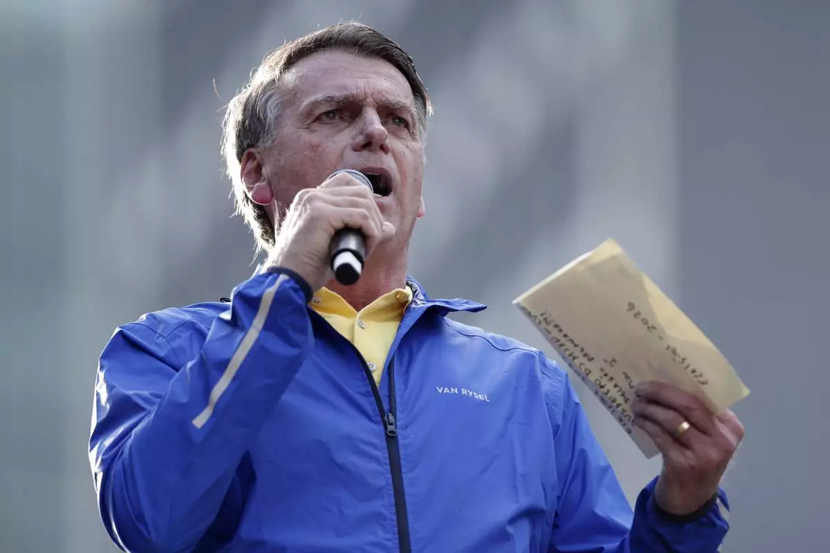 Former President Jair Bolsonaro speaks during a protest against his Supreme Court trial, in which he is accused of involvement in a 2022 coup attempt, in Sao Paulo, Sunday, June, 29, 2025. (AP Photo/Ettore Chiereguini)