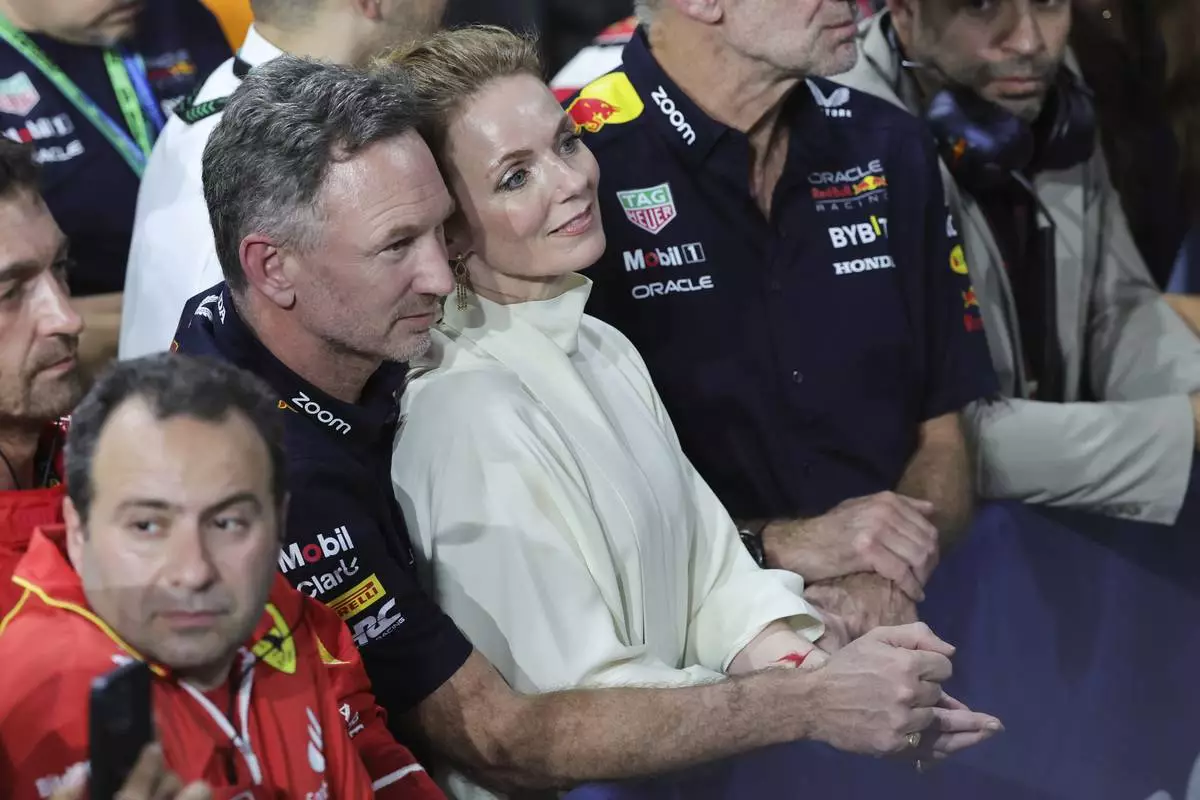 FILE -Red Bull team principal Christian Horner is flanked by his wife Geri Alliwell after the Formula One Saudi Arabian Grand Prix at the Jeddah Corniche Circuit, in Jedda, Saudi Arabia, March 9, 2024. (AP Photo/Giuseppe Cacace/Pool, File)