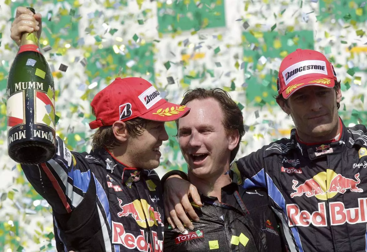 FILE -First place Red Bull driver Sebastian Vettel, of Germany, left, Red Bull team principal Christian Horner, center, and second place Red Bull driver Mark Webber, of Australia, celebrate on the podium after winning Brazil's Formula One Grand Prix at the Interlagos race track in Sao Paulo, Brazil, Nov. 7, 2010. (AP Photo/Luca Bruno), File)