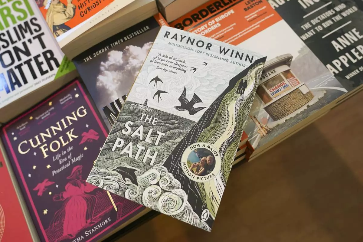 A copy of "The Salt Path", by Raynor Winn is on display in a book store, in London, Friday, July 11, 2025. (AP Photo/Alberto Pezzali)