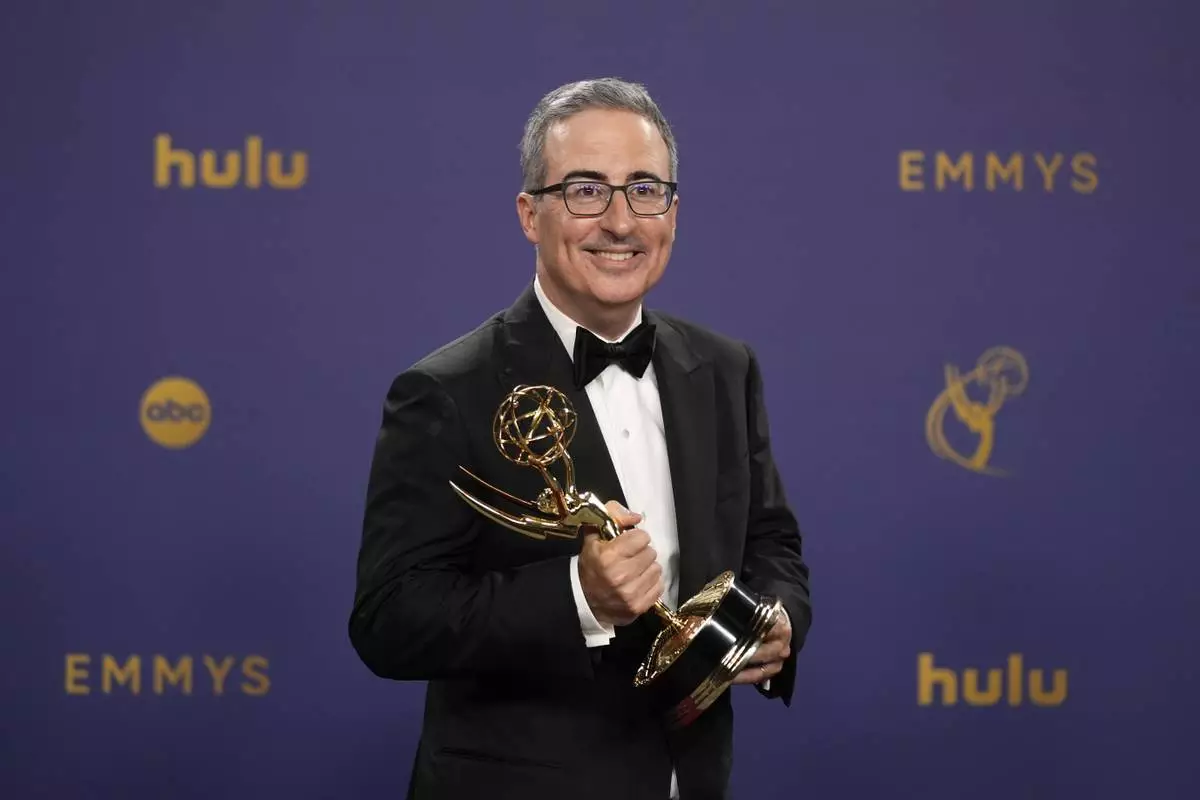FILE - John Oliver poses in the press room with the award for outstanding scripted variety series for "Last Week Tonight With John Oliver" during the 76th Primetime Emmy Awards on Sunday, Sept. 15, 2024, at the Peacock Theater in Los Angeles. (AP Photo/Jae C. Hong, file)