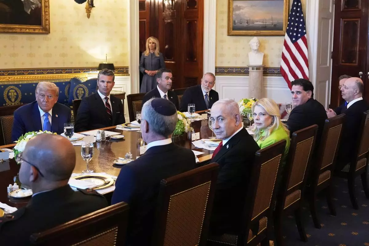 President Donald Trump, from back row left, Defense Secretary Pete Hegseth, CIA Director John Ratcliffe and U.S. Ambassador to Israel Mike Huckabee, meet with Israeli Ambassador to the U.S. Yechiel Leiter, front row from second left, Israel's Prime Minister Benjamin Netanyahu, Netanyahu's wife Sara Netanyahu, Israel's Strategic Affairs Minister Ron Dermer, Israel's National Security Council head Tzachi Hanegbi and Israel's Cabinet Secretary Yossi Fuchs in the Blue Room of the White House, Monday, July 7, 2025, in Washington. (AP Photo/Alex Brandon)