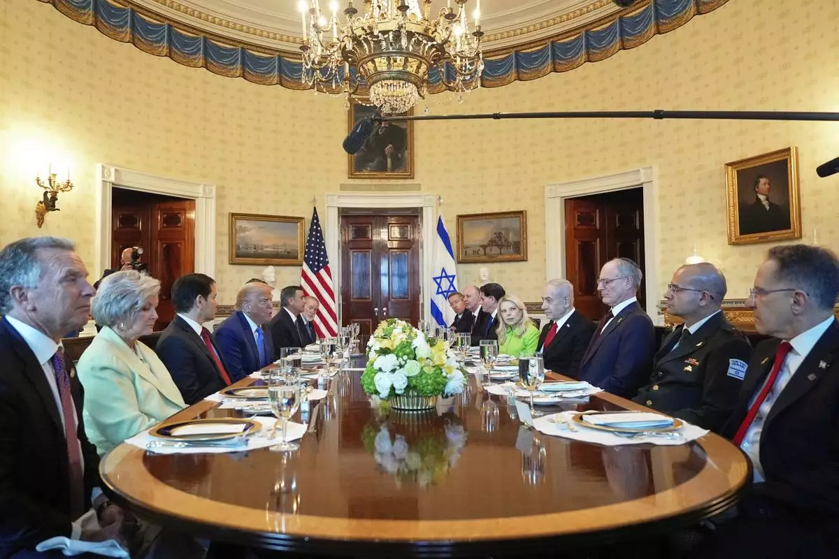 President Donald Trump, fourth from left, meets with Israel's Prime Minister Benjamin Netanyahu, fourth from right, as White House special envoy Steve Witkoff, from left, White House Chief of Staff Susie Wiles, Secretary of State Marco Rubio, Defense Secretary Pete Hegseth, obstructed, CIA Director John Ratcliffe and U.S. Ambassador to Israel Mike Huckabee listen in the Blue Room of the White House, Monday, July 7, 2025, in Washington. (AP Photo/Alex Brandon)