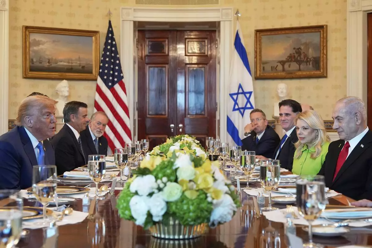 President Donald Trump, left, meets with Israel's Prime Minister Benjamin Netanyahu, right, in the Blue Room of the White House, Monday, July 7, 2025, in Washington. (AP Photo/Alex Brandon)