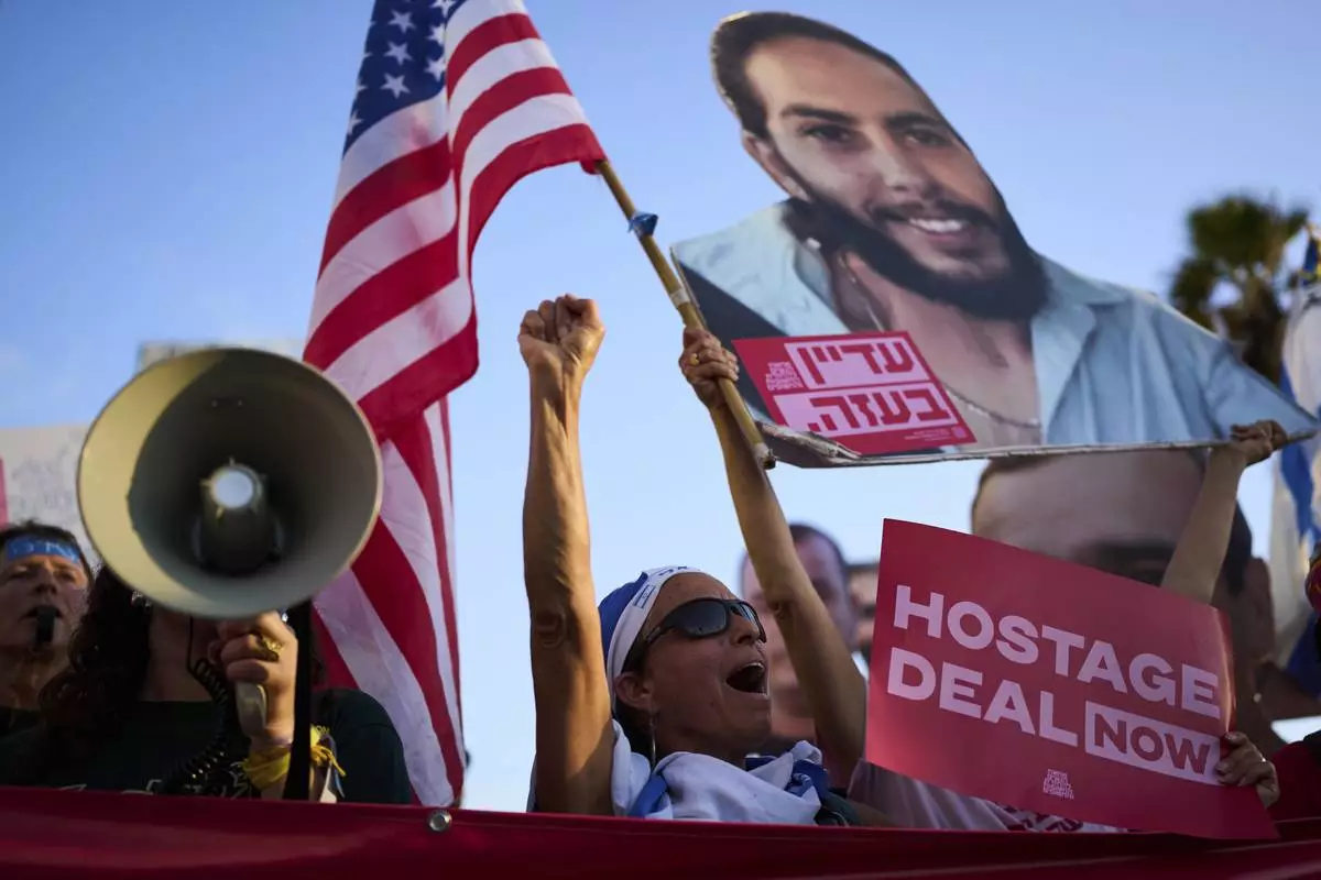 People attend a rally calling for the release of hostages held in the Gaza Strip and urges a ceasefire, in front of the U.S. Embassy branch office in Tel Aviv, Israel, Monday, July 7, 2025, ahead of the planned meeting between U.S. President Donald Trump and Israeli Prime Minister Benjamin Netanyahu. (AP Photo/Oded Balilty)
