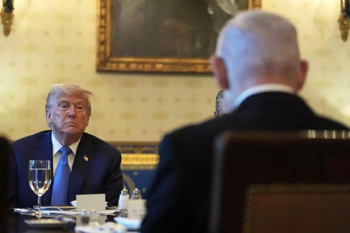 President Donald Trump listens during a meeting with Israel's Prime Minister Benjamin Netanyahu, right, in the Blue Room of the White House, Monday, July 7, 2025, in Washington. (AP Photo/Alex Brandon)