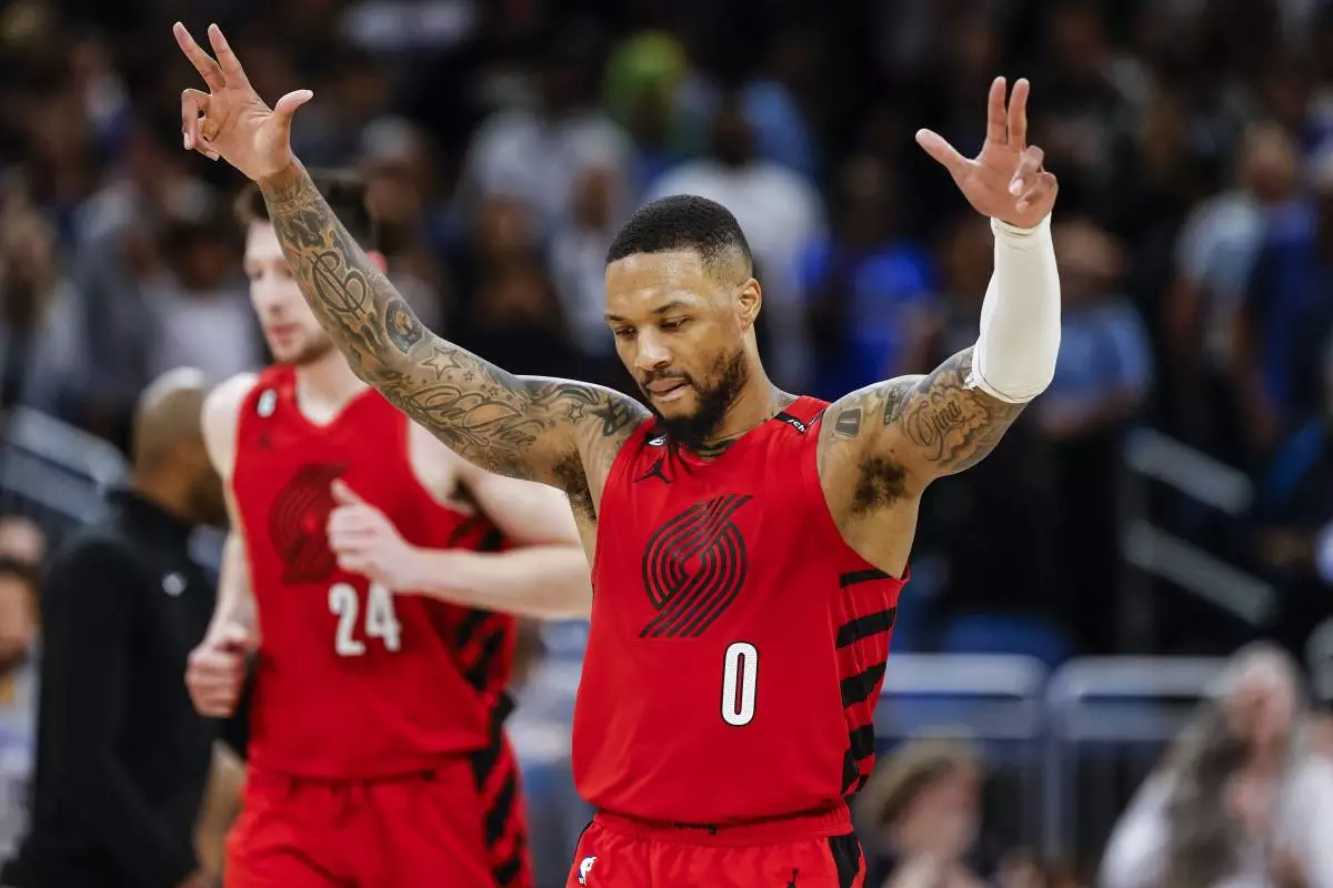 FILE - Portland Trail Blazers guard Damian Lillard (0) celebrates after a shot against the Orlando Magic during the second half of an NBA basketball game, March 5, 2023, in Orlando, Fla. (AP Photo/Kevin Kolczynski, File)