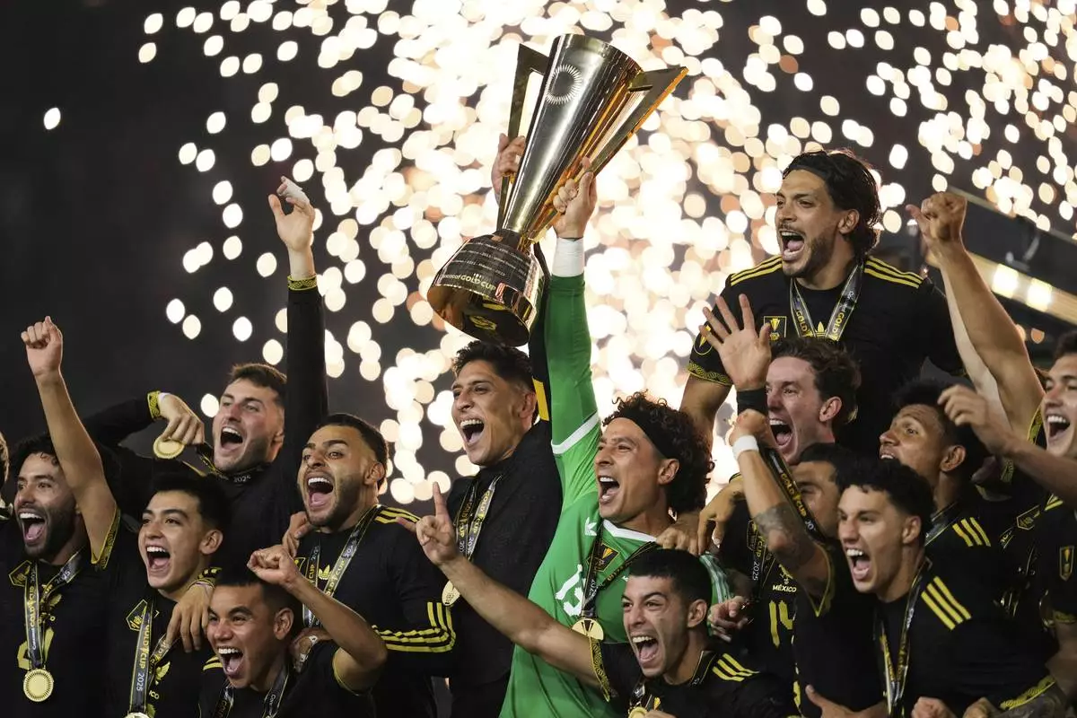 Mexico players and staff celebrate after their win in the CONCACAF Gold Cup final soccer match against the United States in Houston, Sunday, July 6, 2025. (AP Photo/Ashley Landis)