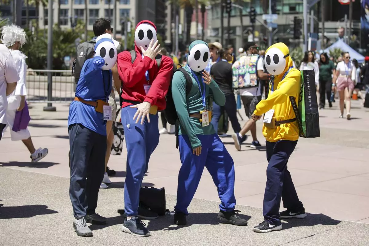 Jeffrey Divincent, Andrew Mckinney, David Florez, and Ethan Mcarthur of Seattle, Wash. dressed as Shy Guys from "Super Mario Bros." attend Comic-Con International on Friday, July 25, 2025, in San Diego. (Photo by Andrew Park/Invision/AP)