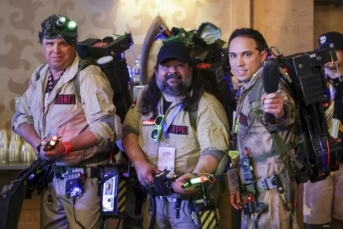 Robert Bowman of Joshua Tree, Calif., from left, Andy Lepe of Indio, Calif., and Kyle Luna of Chula Vista, Calif. dressed as Ghostbusters attend a panel for "The Blues Brothers: The Escape of Joliet Jake" during Comic-Con International on Thursday, July 24, 2025, in San Diego. (Photo by Andrew Park/Invision/AP)