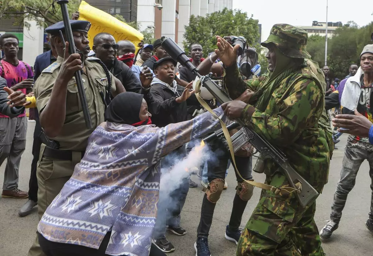 A protester scuffles with the police during a protest over the death in police custody of blogger Albert Ojwang, in Nairobi, Kenya, Thursday, June 12, 2025. (AP Photo/Andrew Kasuku)
