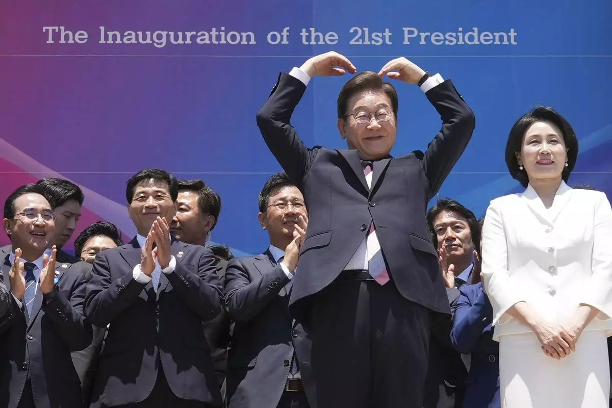South Korean new President Lee Jae-myung and his wife Kim Hea Kyung greet people after attending the presidential inauguration at the National Assembly in Seoul, South Korea, Wednesday, June 4, 2025. (AP Photo/Lee Jin-man, Pool)
