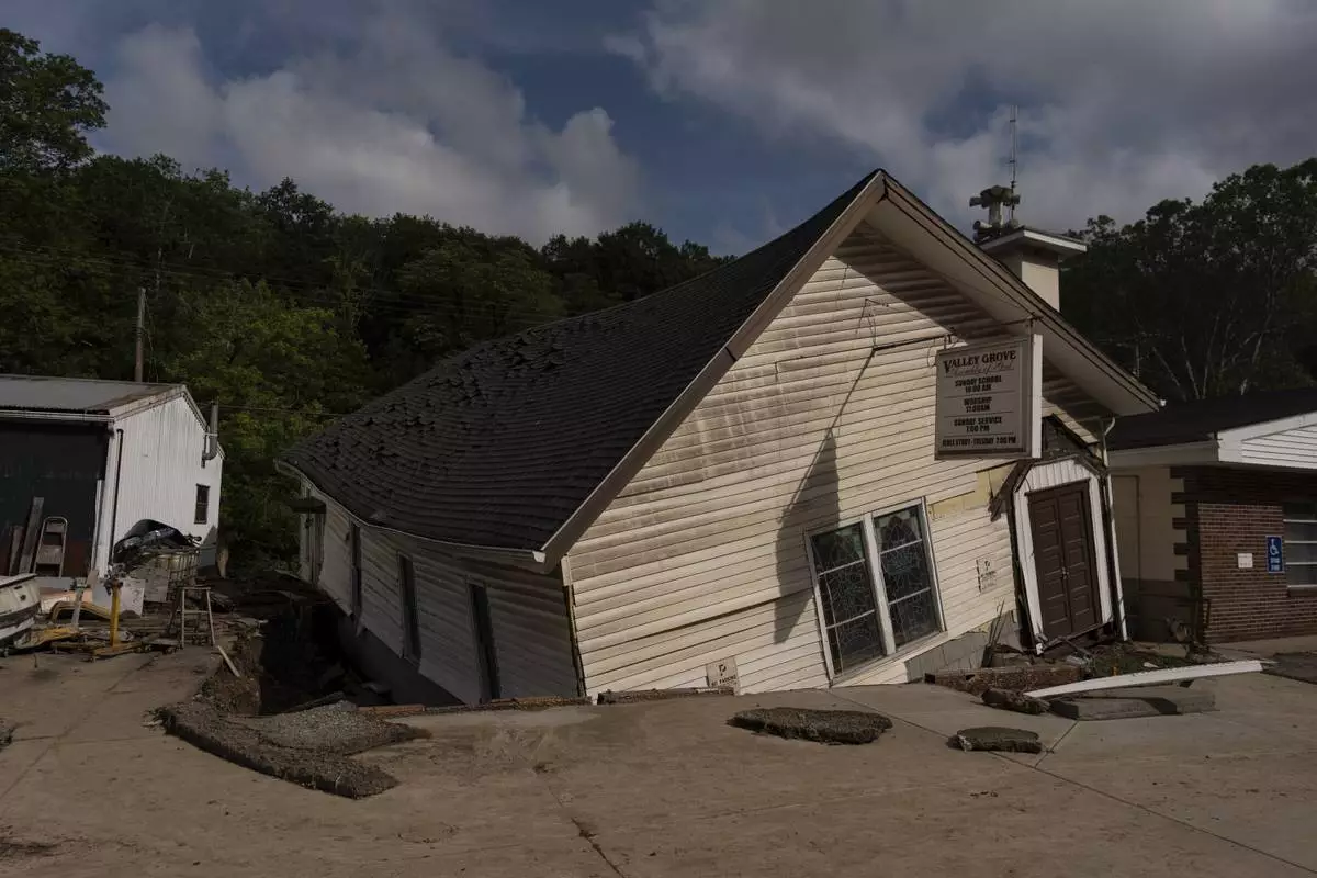 The Valley Grove Assembly of God, twisted and moved from its foundation by floodwaters, Monday, June 16, 2025, in Valley Grove, W.Va. (AP Photo/Carolyn Kaster)
