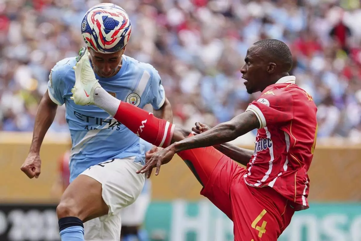 Wydad AC's Thembinkosi Lorch receives the ball in front of Manchester City's Vitor Reis during the Club World Cup group G soccer match in Philadelphia, Wednesday, June 18, 2025. (AP Photo/Derik Hamilton)