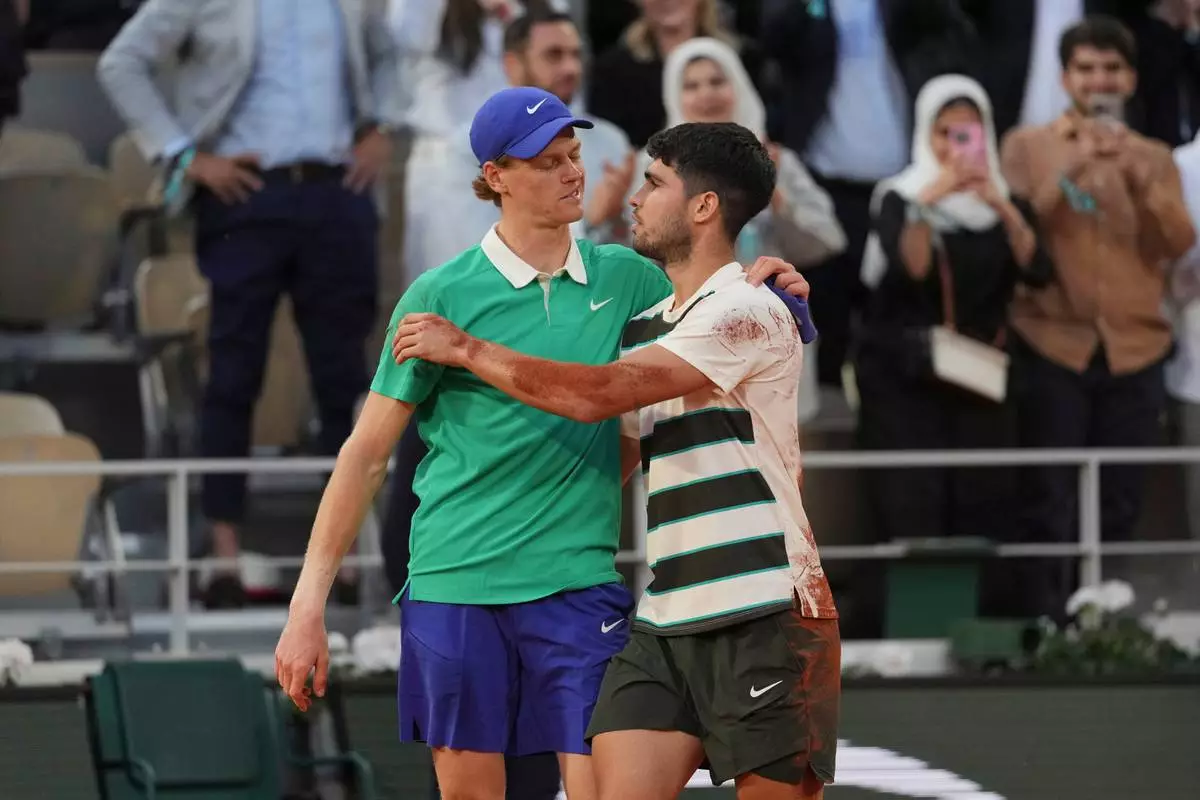 FILE - Winner Spain's Carlos Alcaraz, right, and Italy's Jannik Sinner hug after the final match of the French Open tennis tournament at the Roland-Garros stadium in Paris, June 8, 2025. (AP Photo/Thibault Camus, File)