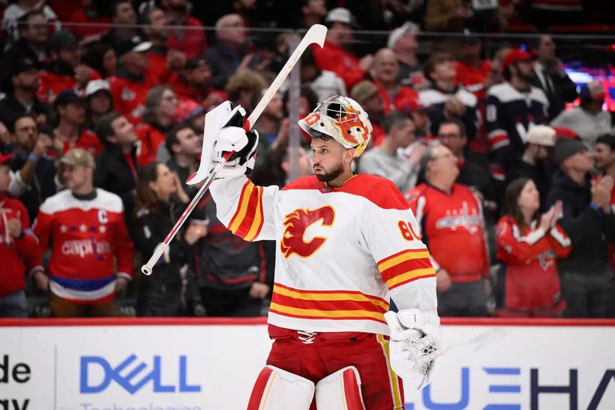 FILE - Calgary Flames goaltender Dan Vladar (80) looks on during the first period of an NHL hockey game against the Washington Capitals, Feb. 25, 2025, in Washington. (AP Photo/Nick Wass, File)