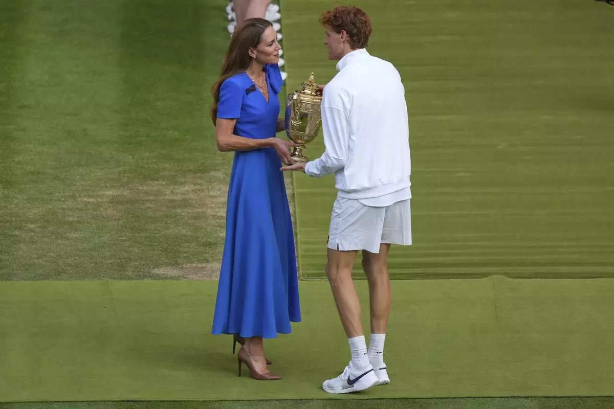 Italy's Jannik Sinner receives the trophy from Kate, Princess of Wales, after beating Carlos Alcaraz of Spain to win the men's singles final at the Wimbledon Tennis Championships in London, Sunday, July 13, 2025. (AP Photo/Joanna Chan)