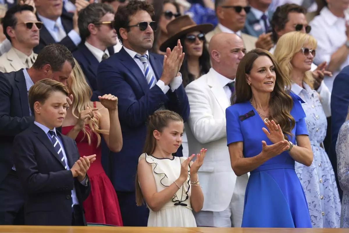 Britain's Kate, Princess of Wales, right, Prince George, left, and Princess Charlotte applaud as they watch Jannik Sinner of Italy and Carlos Alcaraz of Spain during their men's singles final match at the Wimbledon Tennis Championships in London, Sunday, July 13, 2025.(AP Photo/Kirsty Wigglesworth)