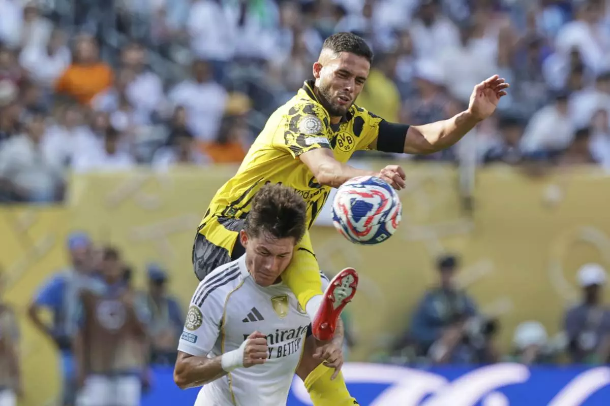 Borussia Dortmund's Yan Couto, top, and Real Madrid's Fran Garcia battle for the ball during the Club World Cup quarterfinal soccer match between Real Madrid and Borussia Dortmund in East Rutherford, N.J., Saturday, July 5, 2025. (AP Photo/Adam Hunger)