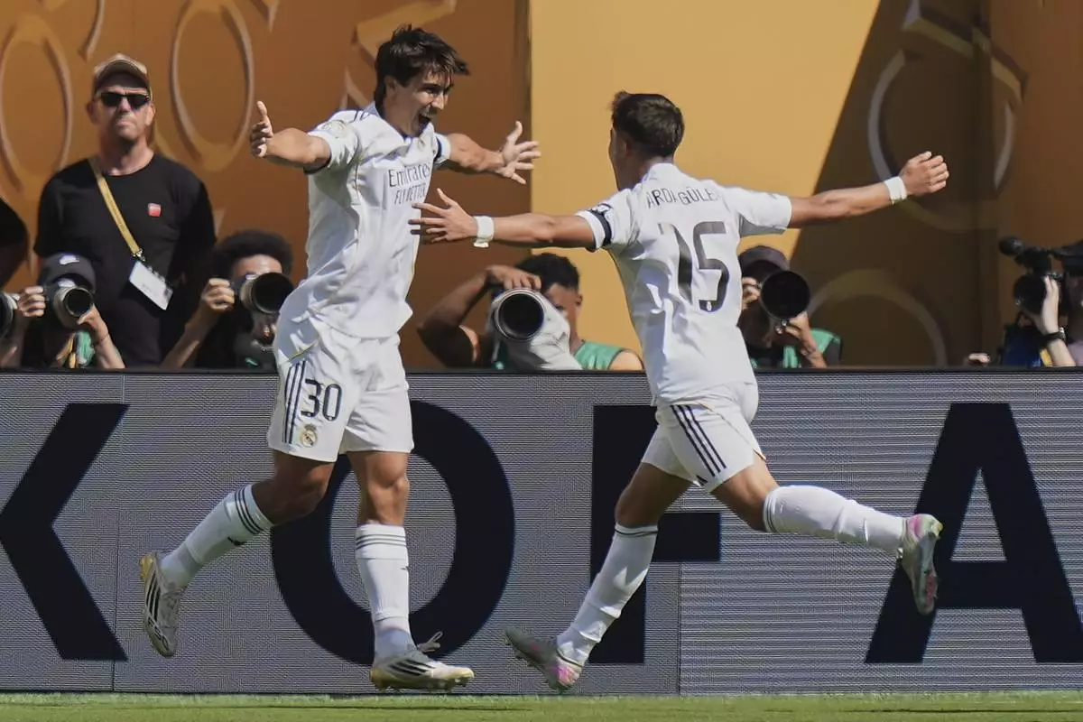 Real Madrid's Gonzalo Garcia, left, and Arda Guler celebrate after Garcia scored a goal against Borussia Dortmund during the first half of a Club World Cup quarterfinal soccer match, Saturday, July 5, 2025 in East Rutherford, N.J. (AP Photo/Frank Franklin II)